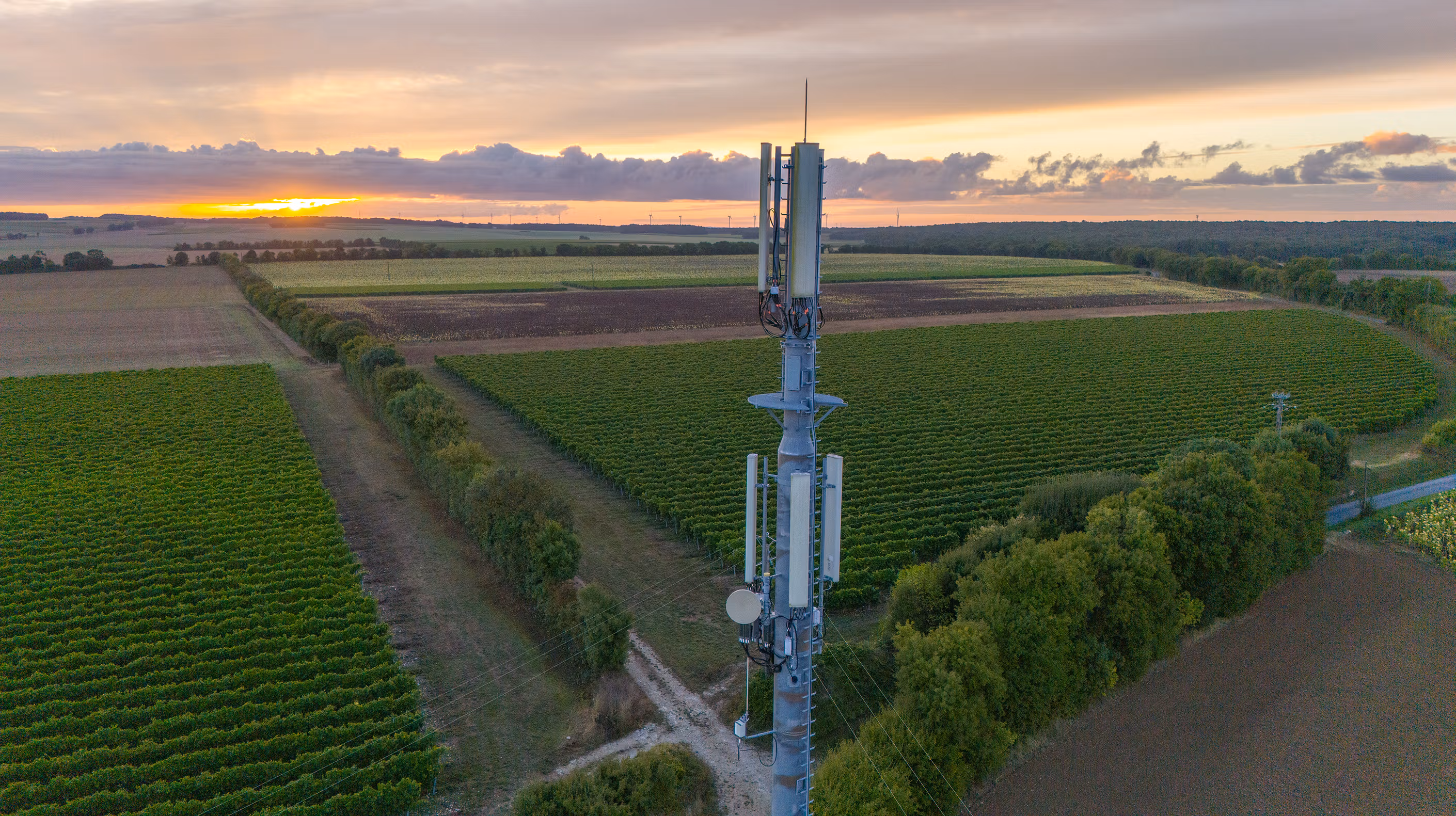 5G cell tower standing over a field in a rural location